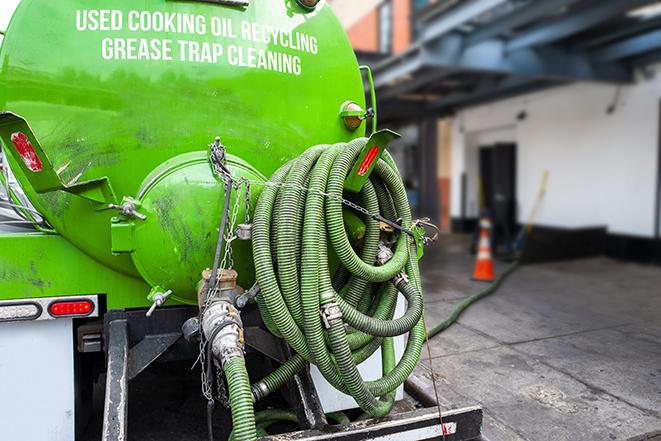 a grease trap being pumped by a sanitation technician in Gwynedd Valley